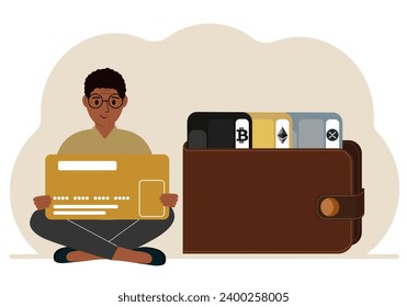 A man holds a card, next to a wallet with different cards for cryptocurrencies. Internet wallet, digital money transactions, exchange platform, cold wallet or hardware wallet.