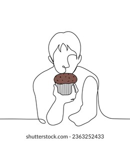 man holds a chocolate cupcake in front of him and looks at it - one line art vector. concept craving for sweets, sweet tooth, diet failure