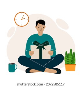 A man holds a gift and sits cross-legged. Young man holding a gift box. Poster, postcard, banner. Flat vector