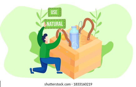 A man holds an inscription in his hands. Wooden box with comb, brush and plastic water bottle inside. Use of natural bath accessories. Environmentally friendly. Save the planet concept. Ecology