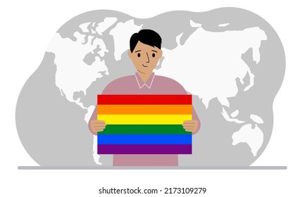 A man holds an lgbt flag in his hands against the backdrop of a world map.