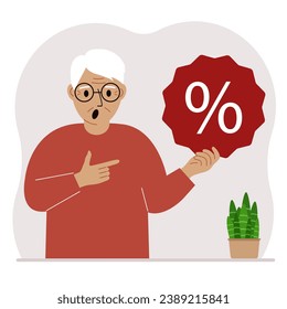 A man holds a percent sign in his hand. The concept of percentage, discount, promotion, interest rate, percent discount in shopping.