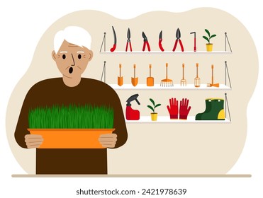 A man holds a plant in his hands against the background of gardening tools. Gardening concept.