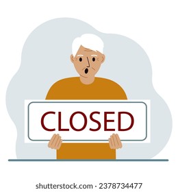 A man holds a sign with the text Closed in his hands.