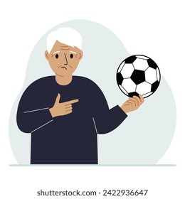 A man holds a soccer ball in his hand. The concept of a player, fan or coach.