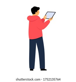 A man holds a tablet in his hands. A young guy works on the Internet. 