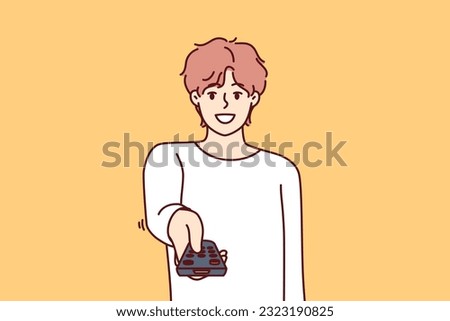 Man holds television remote control switches cable TV channels and smile, choosing interesting show for evening viewing. Happy guy pointing remote at screen wanting to turn off TV box
