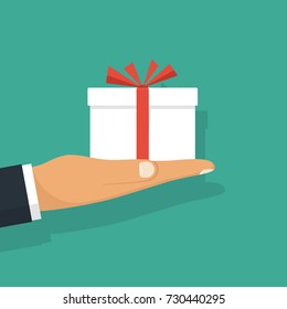 Man holds a white gift box with a red ribbon on outstretched hands. Giving, receiving surprise. Isolated on background. Vector illustration flat design. Delivery of gifts for holiday.