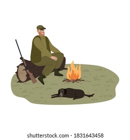 Cazador de hombres calentándose cerca del fuego con perro durante la caza