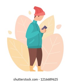 A man in a jacket and a hat stands with a smartphone in his hands. Vector illustration of the character on the background of stylized leaves. Autumn concept for greeting card, business card or poster.