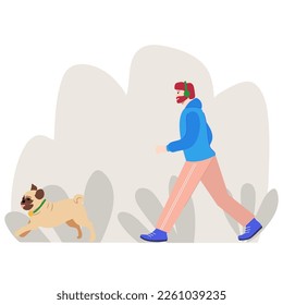 Man jogging with a cheerful dog in the park. Pug, walk, urban environment.