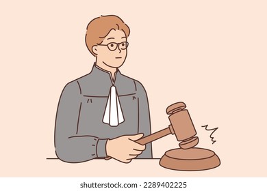 Man judge hitting with wooden gavel sign of final decision and pronouncement of sentence for criminal or violator. Young judge in robe decides on legal dispute between people or companies 