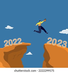 man jumping between 2022 and 2023 years over the sun and through on the gap of hill evening sky.  Business concept,Happy new year 2023.