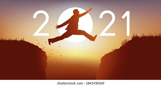 A man jumps over a chasm between two cliffs in front of a zenith sun and symbolize the transition to the new year 2021.