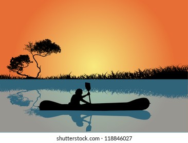 Man kayaking at sunset