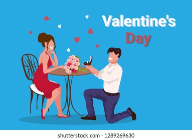 man kneeling holding engagement ring proposing to woman marry him happy valentines day concept couple in love marriage offer male female full length characters horizontal