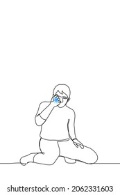 man is kneeling holding a glowing blue star in his fist - one line drawing vector. the concept of catching luck by the tail, making a big dream or a cherished wish come true