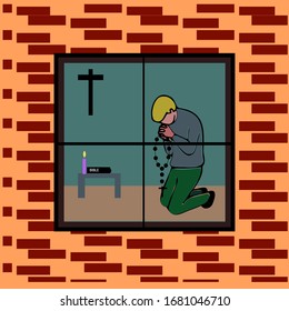 A man kneeling and praying indoors