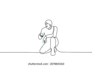 man knelt on one knee to the ground, water flows out of his hand, he looks at it - one line drawing vector. concept of finding water source, geologist or ecologist on marshland, pollution of water bod