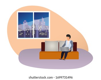 Man with laptop sits on sofa at night