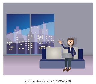 Man with laptop sits on sofa at night