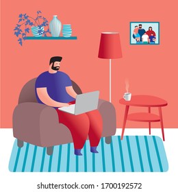 A man with a laptop is sitting in a chair. Work from home during quarantine.