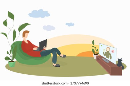 man with a laptop in a soft chair on the lawn conveniently watches news on TV. remote work and outdoor recreation