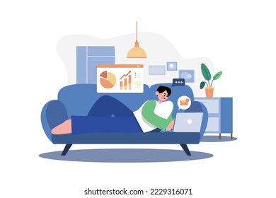 Man Laying On The Couch And Doing Work On A Laptop