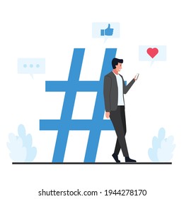 Man leaned against the large hash tag symbol holding the phone.