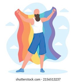 man with lgbtq flag back position