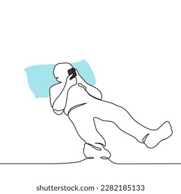 man lies in bed with his head on pillows and a phone in his hands - one line drawing vector. concept internet addiction, addiction to social networks