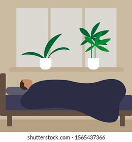 A man lies in bed under a blanket