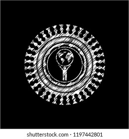 man lifting world icon with chalkboard texture