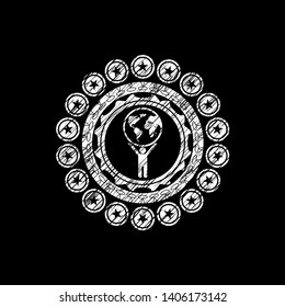 man lifting world icon with chalkboard texture