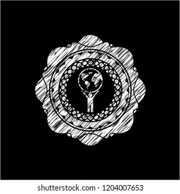 man lifting world icon drawn on a chalkboard