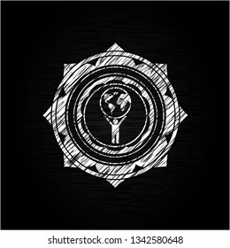 man lifting world icon drawn on a chalkboard
