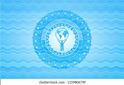man lifting world icon inside light blue water style badge.