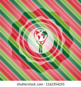 man lifting world icon inside christmas colors style badge.
