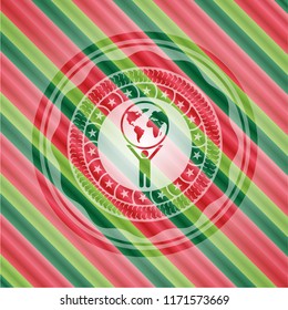 man lifting world icon inside christmas style badge..