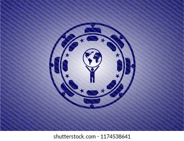 man lifting world icon inside badge with denim background