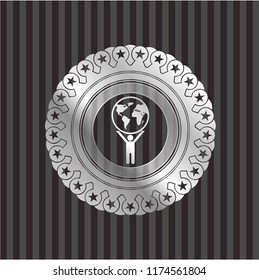 man lifting world icon inside silver shiny badge