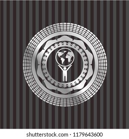 man lifting world icon inside silvery shiny badge
