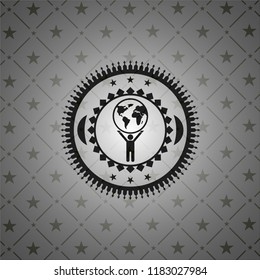 man lifting world icon inside dark emblem