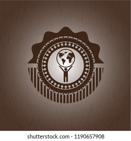 man lifting world icon inside wooden emblem. Vintage.
