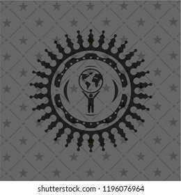 man lifting world icon inside dark emblem
