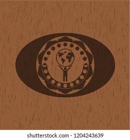man lifting world icon inside wood badge or emblem