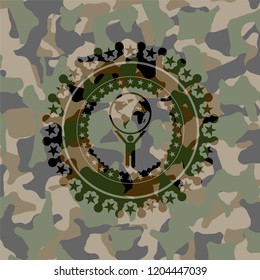 man lifting world icon inside camouflage emblem