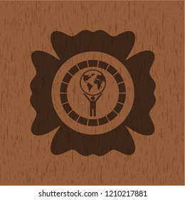 man lifting world icon inside badge with wood background
