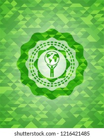 man lifting world icon inside green emblem. Mosaic background