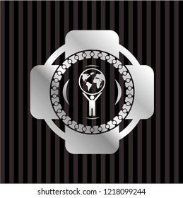 man lifting world icon inside silver shiny emblem